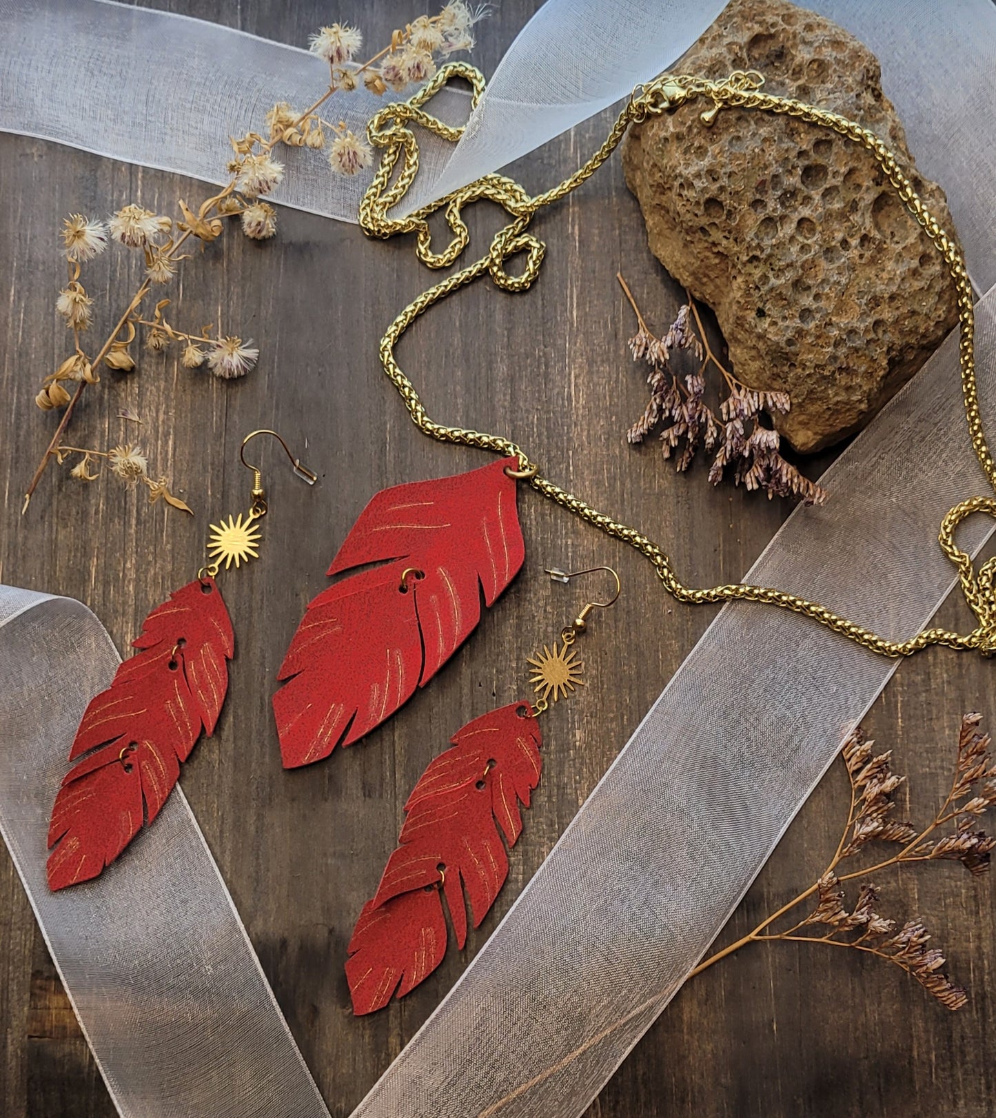 feathers in suede with very light touches of gold. The rope necklace is 18k gold plated. This is a very light thin suede material.